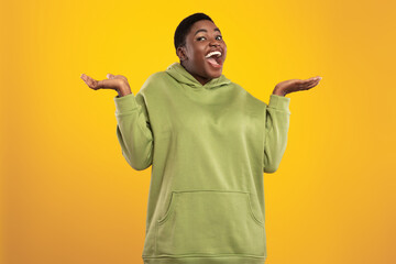 A joyful individual shows excitement and happiness while shrugging their shoulders. They wear a...