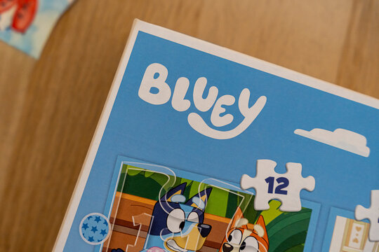 Warsaw, Poland - Dec 16, 2025: Bluey puzzle box featuring characters on a light blue background, ideal for children's game night and family activities.