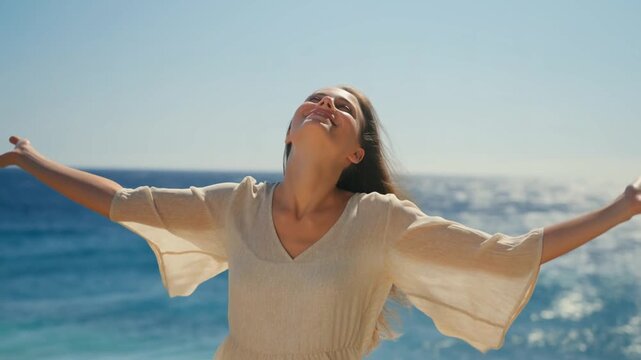A joyous woman standing by the sea, embracing the beauty of nature Stock Video