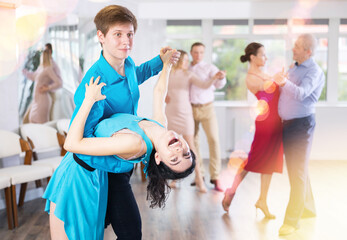 Fototapeta premium Young couple rehearsing and dancing in dance class