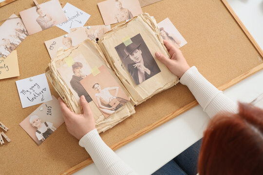 Woman making family tree at table