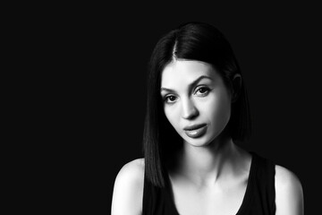 Fototapeta premium Beautiful young woman with short hair on dark background