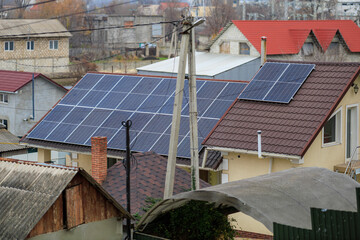 Fototapeta premium Solar panels on residential rooftops in neighborhood