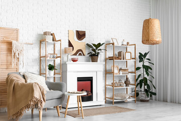Fototapeta premium Interior of modern living room with fireplace, shelving units and armchair