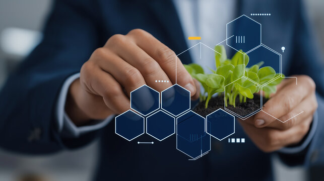 Businessperson nurturing small plant with futuristic hexagon interface overlays symbolizing sustainable innovation. - Powered by Adobe