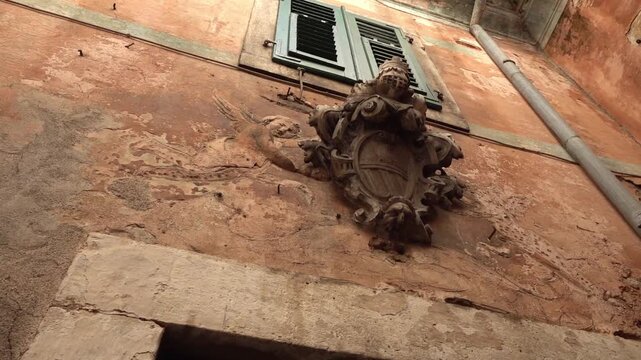 Old crest on a wall of an old house, Kotor, Montenegro, pivoting clip
