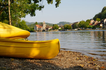 Beach and kayaks at Beaulieu-sur-Dordogne village in France