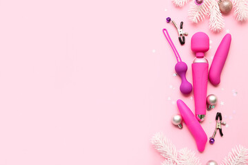 Sex toys and Christmas decor on pink background