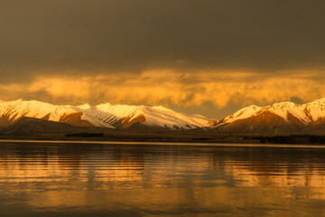 Orange  and brown  sunset hues over Lake Tekapo as night falls