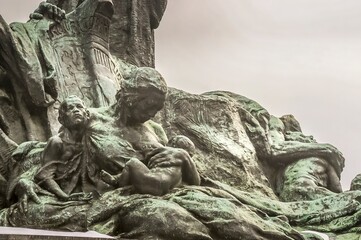 Mother with two children in Jan Hus Memorial in Old town square in Prague, Czech Republic