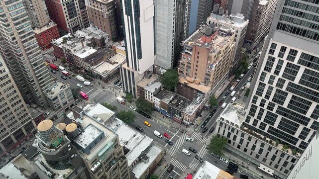 Day scene of top view of New York City Manhattan street with traffic and skyscrapers around