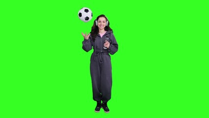 Lady in headphones throwing up ball, holding bottle of water on the chroma key