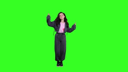 Woman dancing, moving her arms and spinning around herself on the chroma key