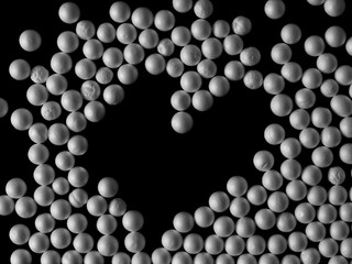 white circle styrofoam ball in shape heart, frame isolated on black background, pattern texture foam, clipping path