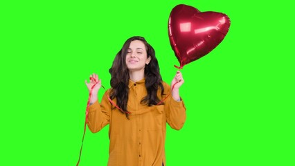Happy pretty lady holding heart shape air balloon on the chroma key