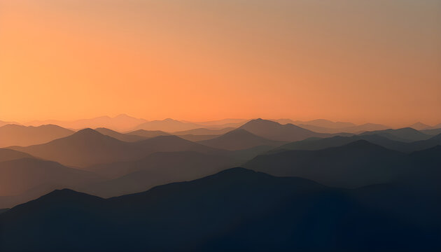 오렌지 톤의 일출과 어두운 산 능선의 고요한 풍경