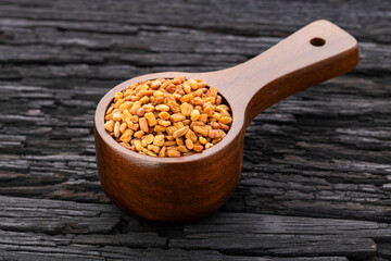 Natural aromatic fenugreek seeds in the measuring spoon - Natural food