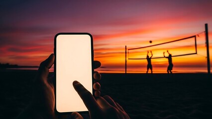 Sunset volleyball game captured on smartphone with blank screen.