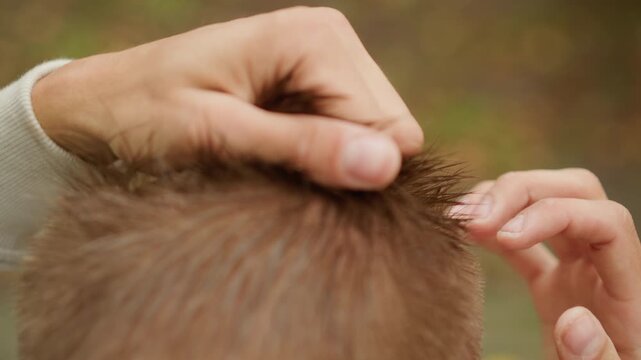 Relaxed grooming following workout session, Casual grooming after exercise with raindrops on hair, Informal hairstyle touchup following physical activity under rainy weather conditions