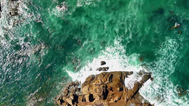 Drone rising above Atlantic ocean waves and rocky coastline in Ancora, Portugal