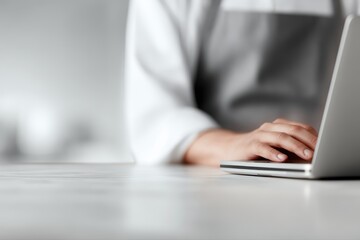 focused worker typing on laptop, clean workspace and efficiency concept