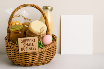 Support small business gift basket with handmade food, spa products, blank card, sustainable packaging on neutral background