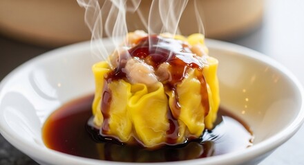 Steaming dim sum dumpling drizzled with dark sauce in white bowl