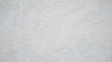 Bright White Textured Wall Surface with Rough Plaster Finish and Artistic Brush Marks Creating a Modern Abstract Background