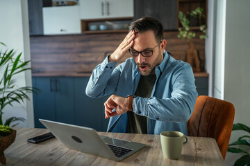 Man checking watch feeling stressed about missed deadline