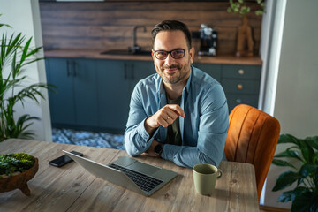 Fototapeta premium Man smiling working from home office freelance lifestyle