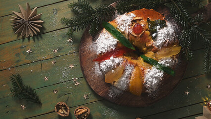 Traditional Portuguese Bolo Rei Christmas Cake with Candied Fruit on a Rustic Table