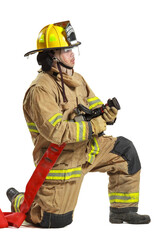 Firefighter kneeling with fire hose nozzle in protective gear on white
