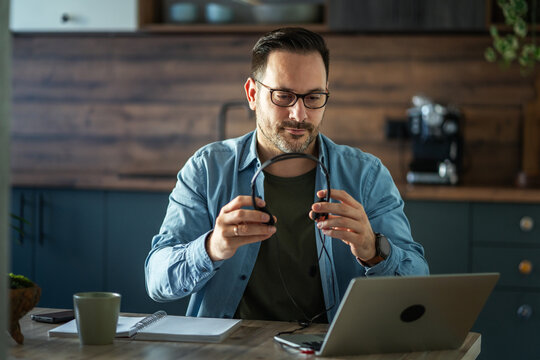Man preparing for remote work video call at home office - Powered by Adobe