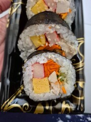 Makizushi is a type of sushi made with sushi rice and filling ingredients rolled using sheets of seaweed (nori).