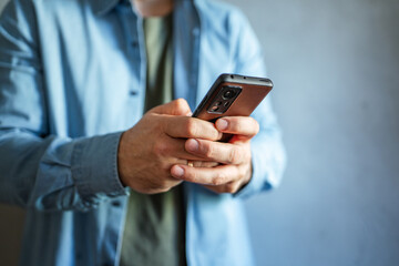 Person browsing internet on mobile phone using hands
