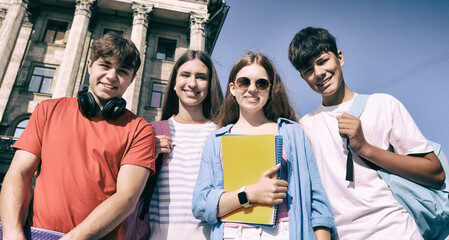 Students in campus. Teenage girls and boys walking outdoors together