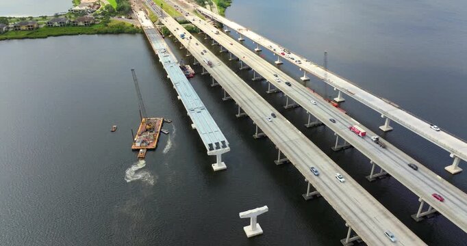 Driving traffic cars on freeway bridge road under construction. Building traffic infrastructure on American roadway.
