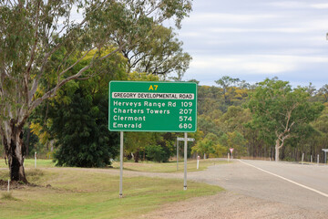 Road sign giving distances to Herveys Range Road, Charters Towers, Clermont and Emerald on the Gregory Developmental Road in Queensland, Australia