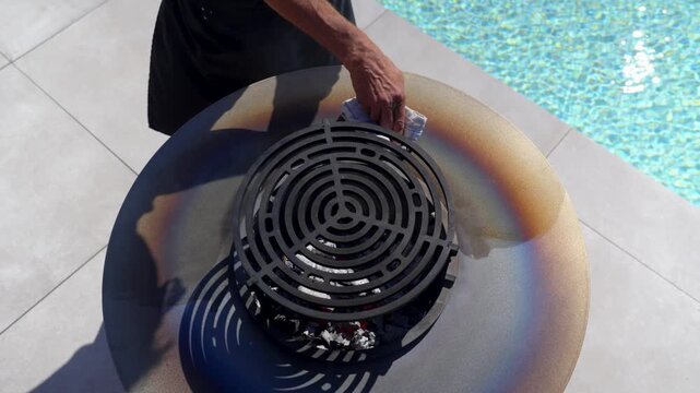 close view of grill surface cleaned beside bright blue pool
