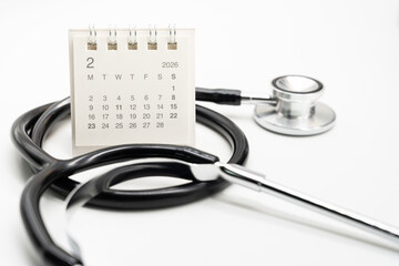 Desk calendar set to FEBRUARY 2026. Doctor Appointment Schedule and Annual Health Checkup Reminder. Preventive medicine, healthcare planning, doctor visits, and timely examinations.