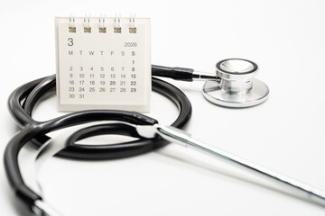 Desk calendar set to MARCH 2026. Doctor Appointment Schedule and Annual Health Checkup Reminder. Preventive medicine, healthcare planning, doctor visits, and timely examinations.