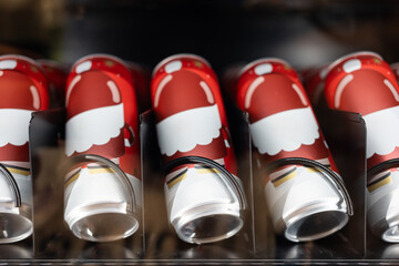Close up of Santa Claus Holiday Cups in Vending Machine. seasonal beverages, office coffee, winter treats, automated retail, and Christmas parties or events.