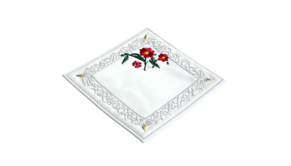 A white, square cloth with lace trim and red flower embroidery. Diamonds on the corners