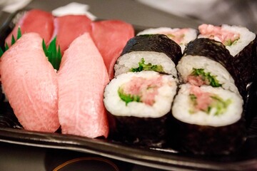 Tuna Nigiri and Maki Roll Assortment on Elegant Black Tray © Bossa Art