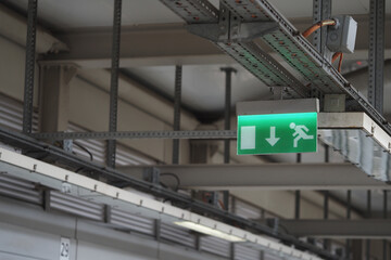 Emergency exit sign in a modern building near a corridor