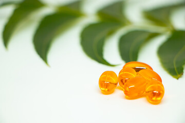 Healthcare concept. Vitamin e capsule isolated on white with medicine background.