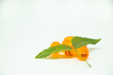 Healthcare concept. Vitamin e capsule isolated on white with medicine background.