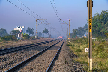 Saffron coloured Vande Bharat Express near Pune India. This is a made in India train set and also known as Train 18.