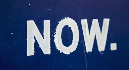 Motivational word 'NOW' on scratched blue background