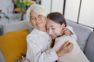 portrait of grandmother with granddaughter  family leisure sits on couch at home